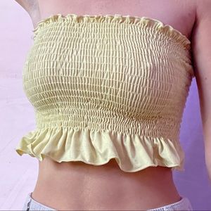 Yellow tube top with frilly hem.
